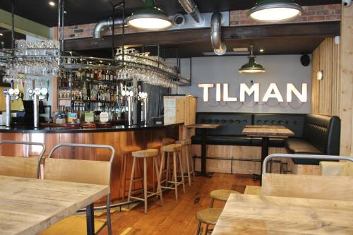 a bar in a restaurant with a sign that reads titan at The Tilman in Barmouth