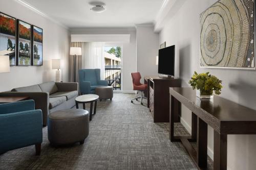 a living room with a couch and a tv at Holiday Inn Resort Lake George by IHG in Lake George
