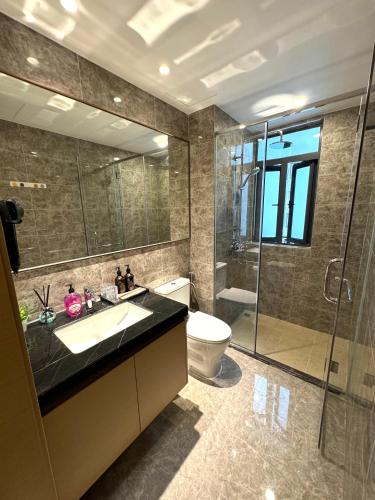 a bathroom with a toilet and a sink and a shower at R&F Princess Cove Swimming View By TGW STUDIO in Johor Bahru