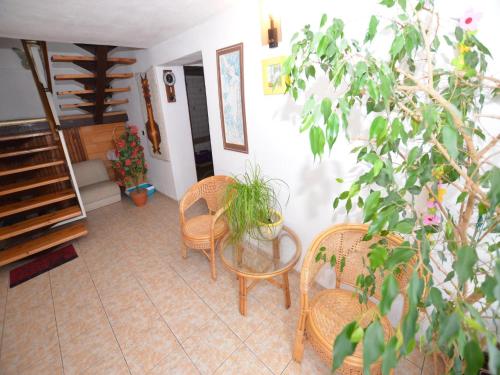 a room with a table and chairs and a staircase at Private Pool & Terrace Stay in Bechyně