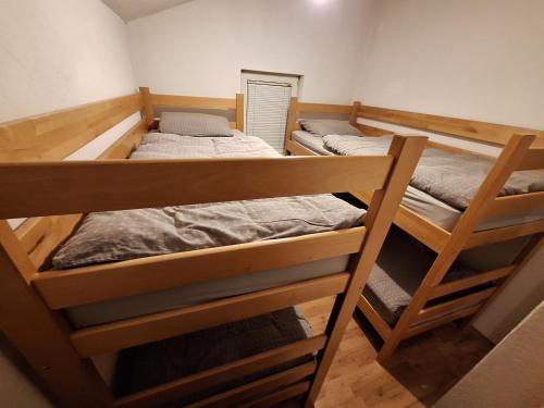 a room with three bunk beds in it at Vikendica Ivan Blidinje in Blidinje