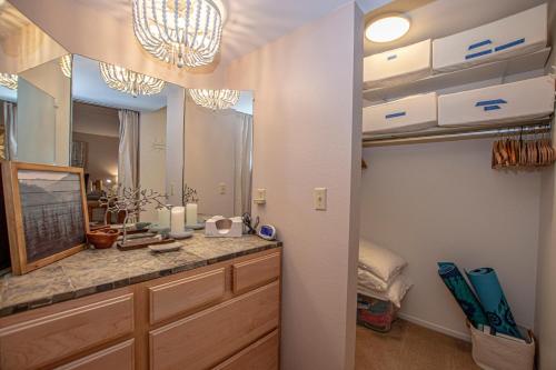 a bathroom with a vanity with a large mirror at Lake Forest Glen # 114 By Hauserman Rentals in Tahoe City