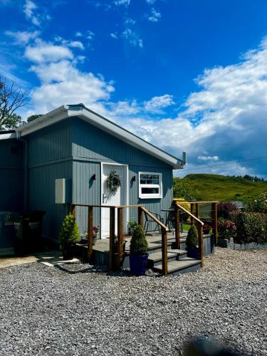a green building with a window and a porch at Rose Cottage in Killybegs