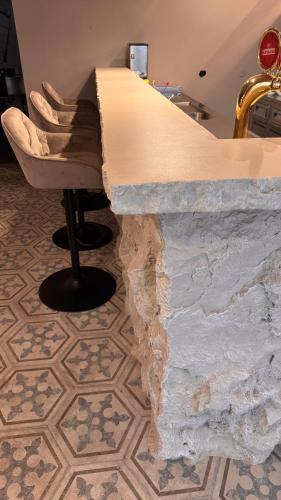 a stone counter in a room with a chair at Hotel Aquarius Dubrovnik in Dubrovnik