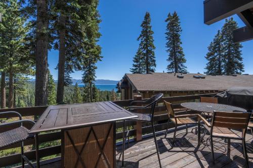 a deck with a table and chairs with a view at Rocky Ridge # 04 By Hauserman Rentals in Tahoe City