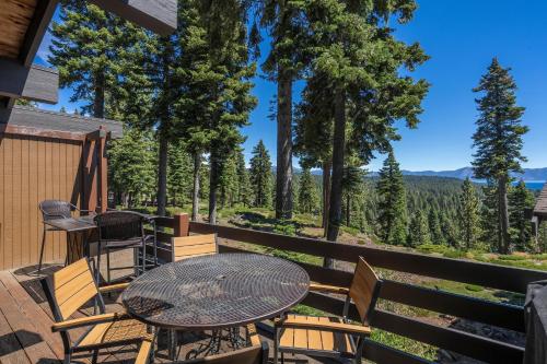 a patio with a table and chairs and trees at Rocky Ridge # 04 By Hauserman Rentals in Tahoe City