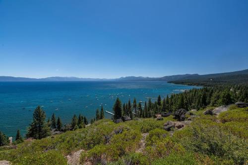 a view of a lake from a hill with trees at Rocky Ridge # 04 By Hauserman Rentals in Tahoe City