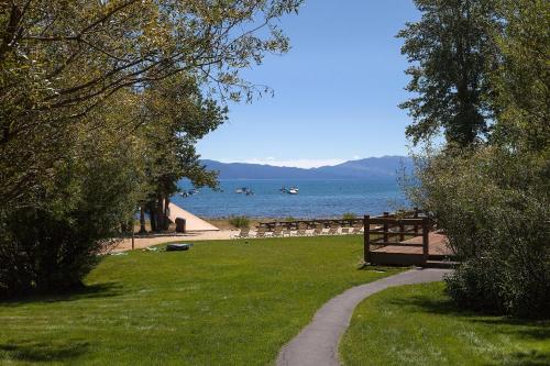 a path through a park next to a body of water at Rocky Ridge # 04 By Hauserman Rentals in Tahoe City