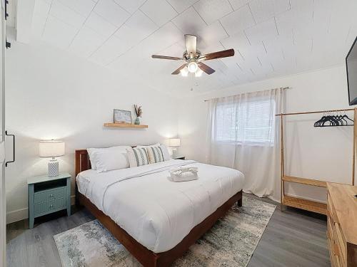 a bedroom with a bed and a ceiling fan at Modern 3BR Retreat with Pool & Fire Pit in Largo