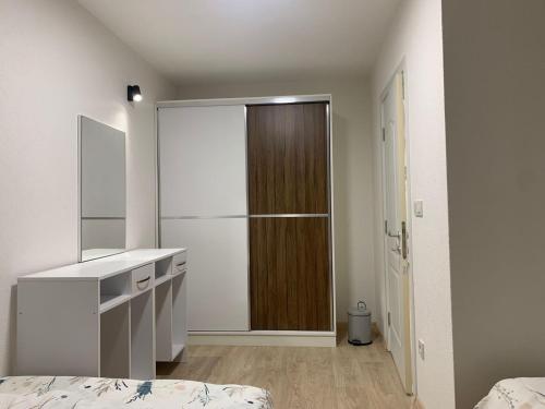 a bedroom with a closet and a bed and a mirror at شقق وفيلا بالبوسنة سراييفو in Blažuj