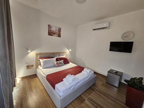 a bedroom with a bed and a television in it at Victoria Houses, Vlore Albania in Vlorë