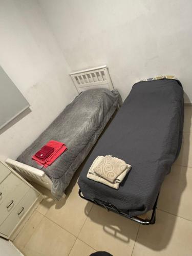 a bed in a room with a black bedvisor at Rincon del Rio Home in Neuquén