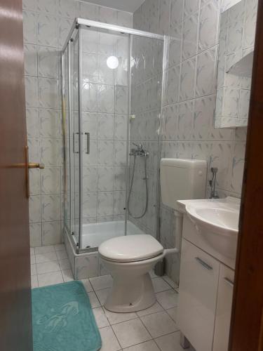 a bathroom with a shower and a toilet and a sink at Villa#12 in Savina