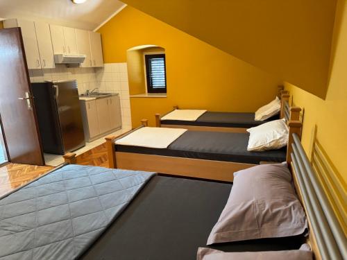 a small room with three beds and a kitchen at Villa#12 in Savina
