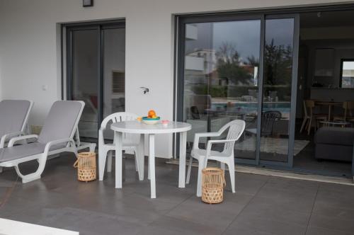 a white table and chairs on a patio at Apartament Alvor in Albur Village Lote A in Alvor
