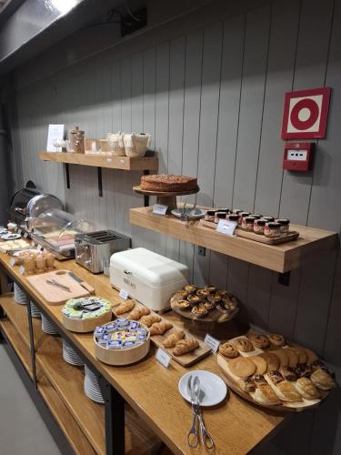 a table with many different types of pastries on it at Descobertas Boutique Hotel by Aspasios in Porto