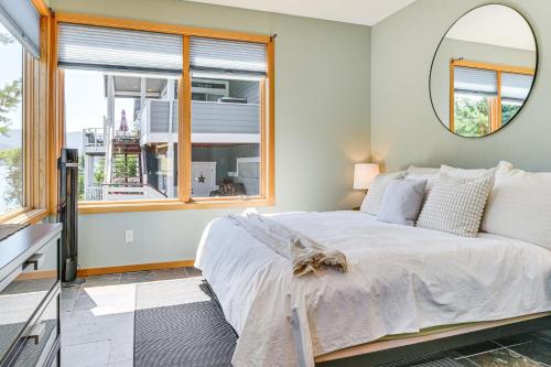 a bedroom with a large bed and a mirror at Modern Summit Lake Escape - Spacious Deck with View! in Kamilche