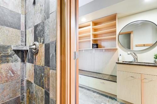 a bathroom with a sink and a mirror at Modern Summit Lake Escape - Spacious Deck with View! in Kamilche