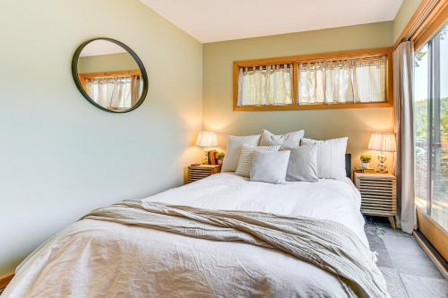 a bedroom with a large bed and a mirror at Modern Summit Lake Escape - Spacious Deck with View! in Kamilche