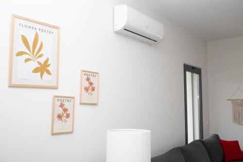 a living room with a couch and a light on a wall at Apartament Alvor in Albur Village Lote A in Alvor
