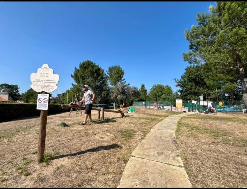 a man and a child playing in a park at Petite maison dans les Landes in Saint-Julien-en-Born
