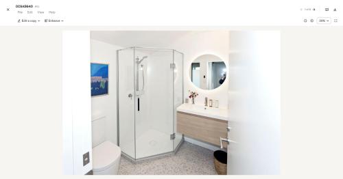a white bathroom with a shower and a toilet at Lansdowne Farm Lodge in Hawkeswood