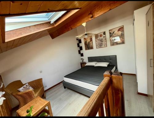 a bedroom with a bed in a attic at Petite maison dans les Landes in Saint-Julien-en-Born