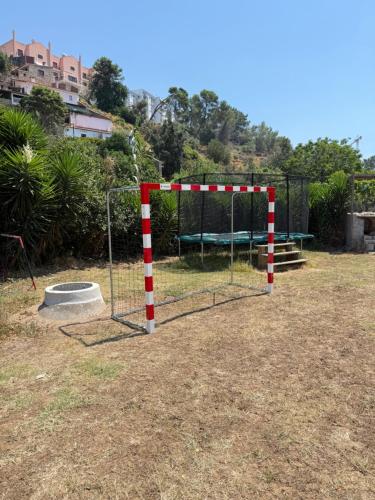 a batting cage in a park with a basketball hoop at Quinta da Villa in Cascais