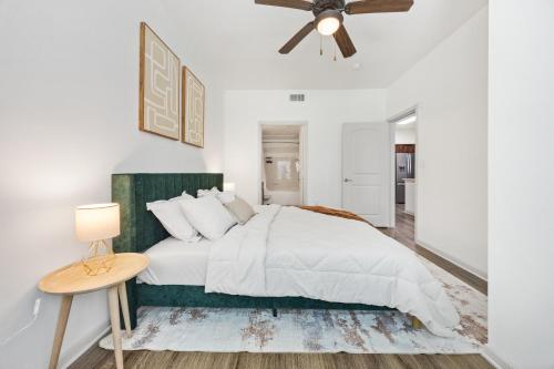 a white bedroom with a bed and a ceiling fan at Brightshaven CoolSprings, Modern 1Bed with EV Parking in Frisco in Frisco
