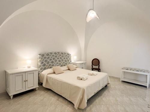 a bedroom with a bed and two night stands at Casa Maristé in Favignana
