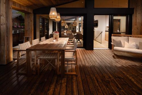a wooden dining table and chairs in a living room at Alpenlodges in Schönau am Königssee
