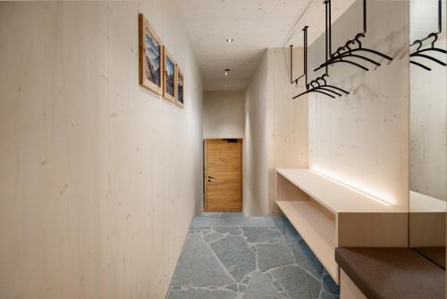 a hallway with white walls and a wooden door at Alpenlodges in Schönau am Königssee