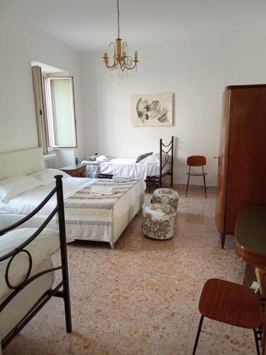 a bedroom with two beds and a table and chairs at B&B Piazza dei Leoni in Sezze
