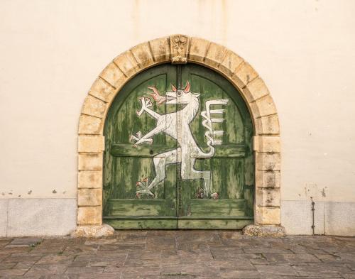 a green door with a dragon painted on it at Skyview Residence - Self Check In - Near City Centre in Graz