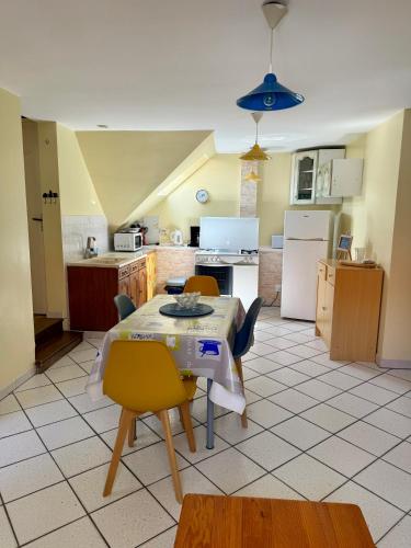 a kitchen with a table and chairs in a room at La parenthèse d'Opale in Wissant