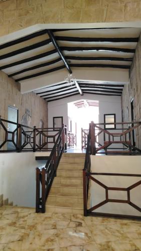 a staircase in a building with wooden railings at Xima Colca in Yanque