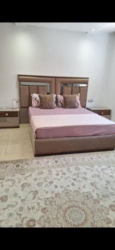a bedroom with a large bed and a rug at Suites au sein d'une Villa au centre ville de Rabat in Rabat