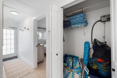 a room with a door open to a room with a closet at Heat of Siesta Village Walk to Beach w heated Pool in Siesta Key