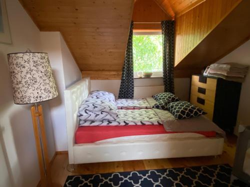 a small bedroom with a bed in a attic at Damentka's Nest in Warsaw
