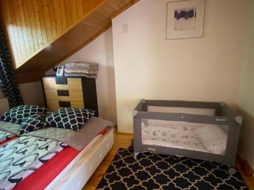 a small bedroom with a bed and a staircase at Damentka's Nest in Warsaw