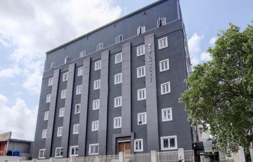 a large gray building with white windows at Super Townhouse RCC Majestic 397 LB Nagar in Hyderabad