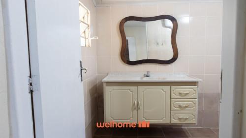 a bathroom with a sink and a mirror on the wall at Sítio em Sarapuí com piscina e lazer completo in Sarapuí