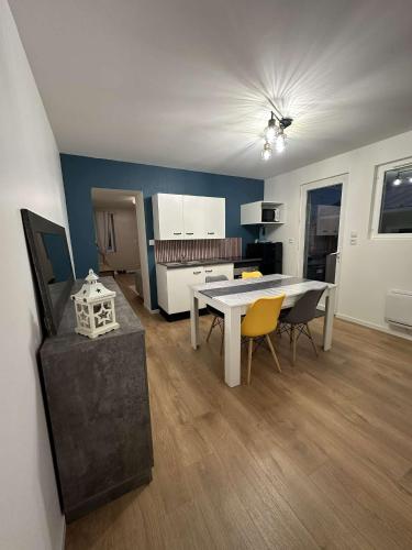 a kitchen and dining room with a table and chairs at 145 désirs in Samer