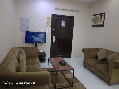 a living room with two couches and a tv at شقق لؤلؤه الفخامه in Al Qunfudhah