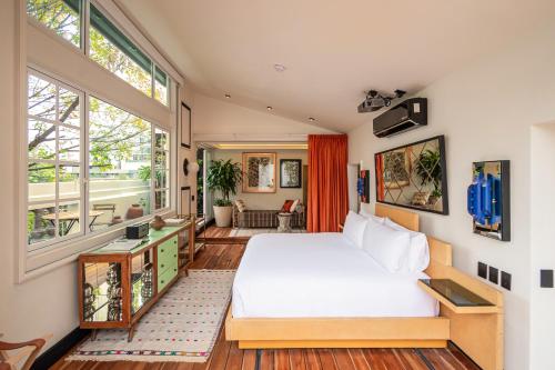 a bedroom with a bed and a large window at La Valise Mexico City, member of Small Luxury Hotels in Mexico City