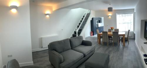 a living room with a couch and a table at Herbert Place in Treherbert
