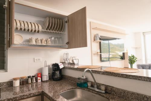 a kitchen with a sink and a counter top at Zona Rosa y Sector TURISTICO in Manizales