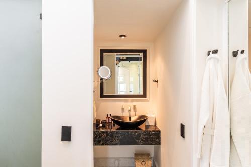 a bathroom with a sink and a mirror at La Valise Mexico City, member of Small Luxury Hotels in Mexico City