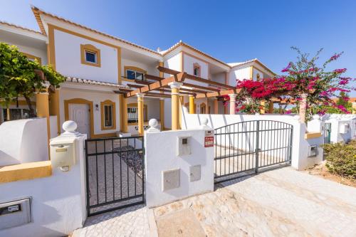 a house with a gate in front of it at Sagres ZEN - 3 Bedroom House in Sagres