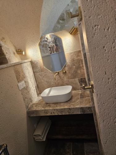 a bathroom with a sink and a mirror at Nid Minéral - Suite voûtée de charme au cœur de Vallon Pont d'Arc in Vallon-Pont-dʼArc